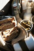 Picnic hamper with sandwiches, drinks and cookies