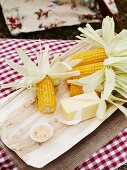 Grilled corn on the cob with butter at a Cowboy and Indian party