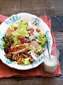 Salad with chicken, walnuts and grapes with blue cheese dressing
