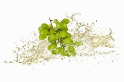 Green grapes with white wine splash