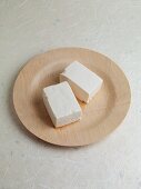 Tofu on a wooden plate