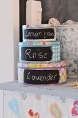 Canisters with writing on them on a painted chest of drawers