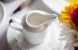 Pitcher of Cream on a Table; Flowers