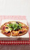 Salami pizza with olives and rocket