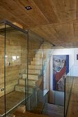 Staircase with glass partition wall in wooden house