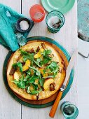 Pizza with pork, provolone, sliced peaches and rocket