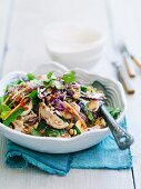 Asian chicken salad with red cabbage, quail eggs and peanuts