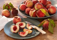 Peaches, whole and sliced, with leaves