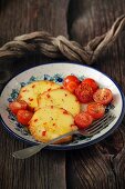 Sheep's cheese fried in honey with cherry tomatoes