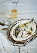 Bream with lemon slices and herbs