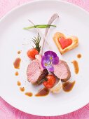 Medium rare lamb chops with heart-shaped puff pastries