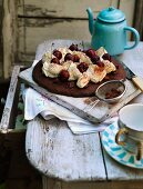 Luxurious chocolate cake with whipped cream and sweet cherries