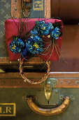 Handbag adorned with decorative plumes