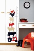 Animals painted next to a yardstick on the wall of a child's room