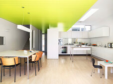 Open-plan kitchen with dining area and suspended ceiling
