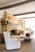Bright living room with rough stone fireplace