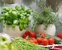 Various herbs and summer vegetables on a garden table