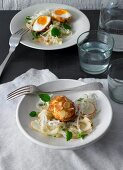 White cabbage and apple salad with breaded cheese eggs