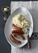 Creamy white cabbage with caraway and sausages