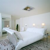 Room in elegant London hotel; rug with pattern of hand-writing, designer sleigh bed and framed picture on ceiling
