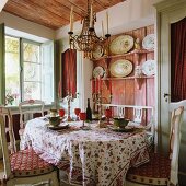French country house style in dining room with rustic shelving and antique chandelier