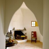 View of open fireplace in simple room through Oriental pointed archway