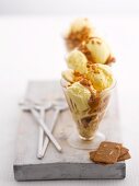 An ice cream sundae with vanilla ice cream, bananas and caramel