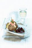 A baked potato with a sour cream dip, salmon and beetroot