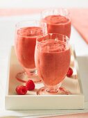 Drei Gläser Himbeer-Cranberry-Smoothies auf Tablett