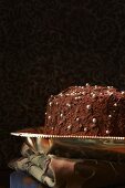 A chocolate cake decorated with silver balls