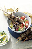 Marinated lamb kebabs on a farmhouse salad (Greece)