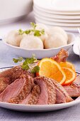 Roast goose with dumplings and oranges