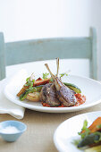 Lamb chops with red pepper sauce and vegetables