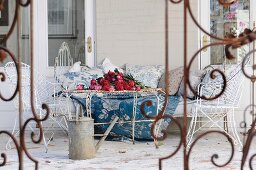 Old metal furniture on farmhouse veranda