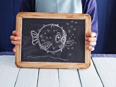 A cartoon fish drawn on a chalkboard