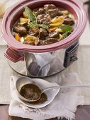 Beef stew being made in a slow cooker