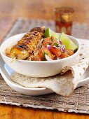 Chicken kebabs with tomato salad and flat bread (India)
