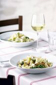 Herb papardelle with artichokes, olives and almonds