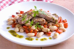 Pork fillet with pesto on a bean and pepper salad