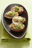 Gratinated egg shells filled with egg, mushrooms and cress