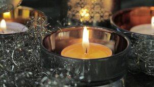 A burning tealight with Christmas decorations