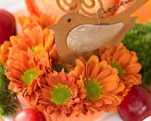 Cupcakes decorated with flowers and bird figurine