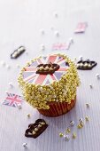 A cupcake decorated with a Union Jack and sugar balls