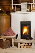 Cosy atmosphere with log fire in living room of renovated wooden hut