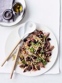 Shoulder of lamb with grapes, freekeh and parsley