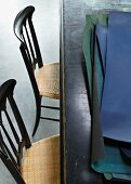 Sheets of coloured paper on wooden table and two Chiavari chairs