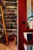 Ladies' shoes on floor-to-ceiling white shelving in niche