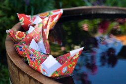 Paper boats on miniature pond