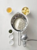 Flour in a sieve, butter, salt, thyme, egg, water and a mixer