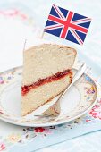 A slice of sponge cake with a small flag